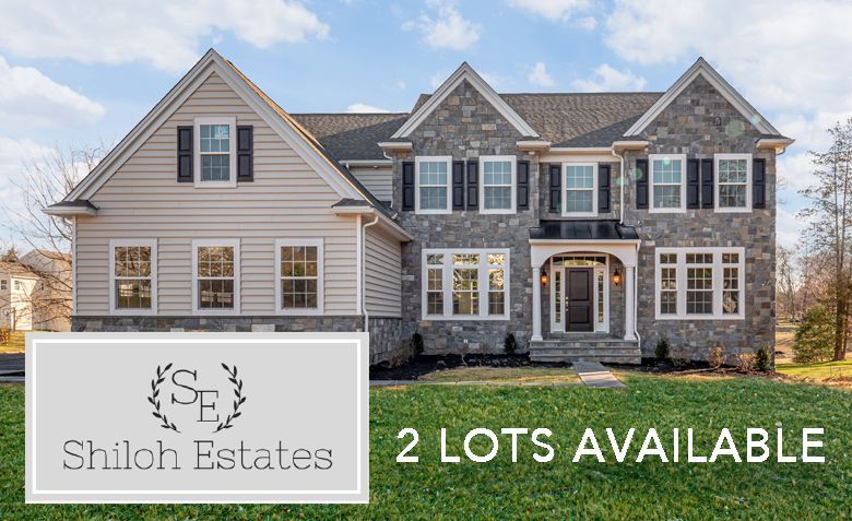 A large house with lots of windows is for sale.