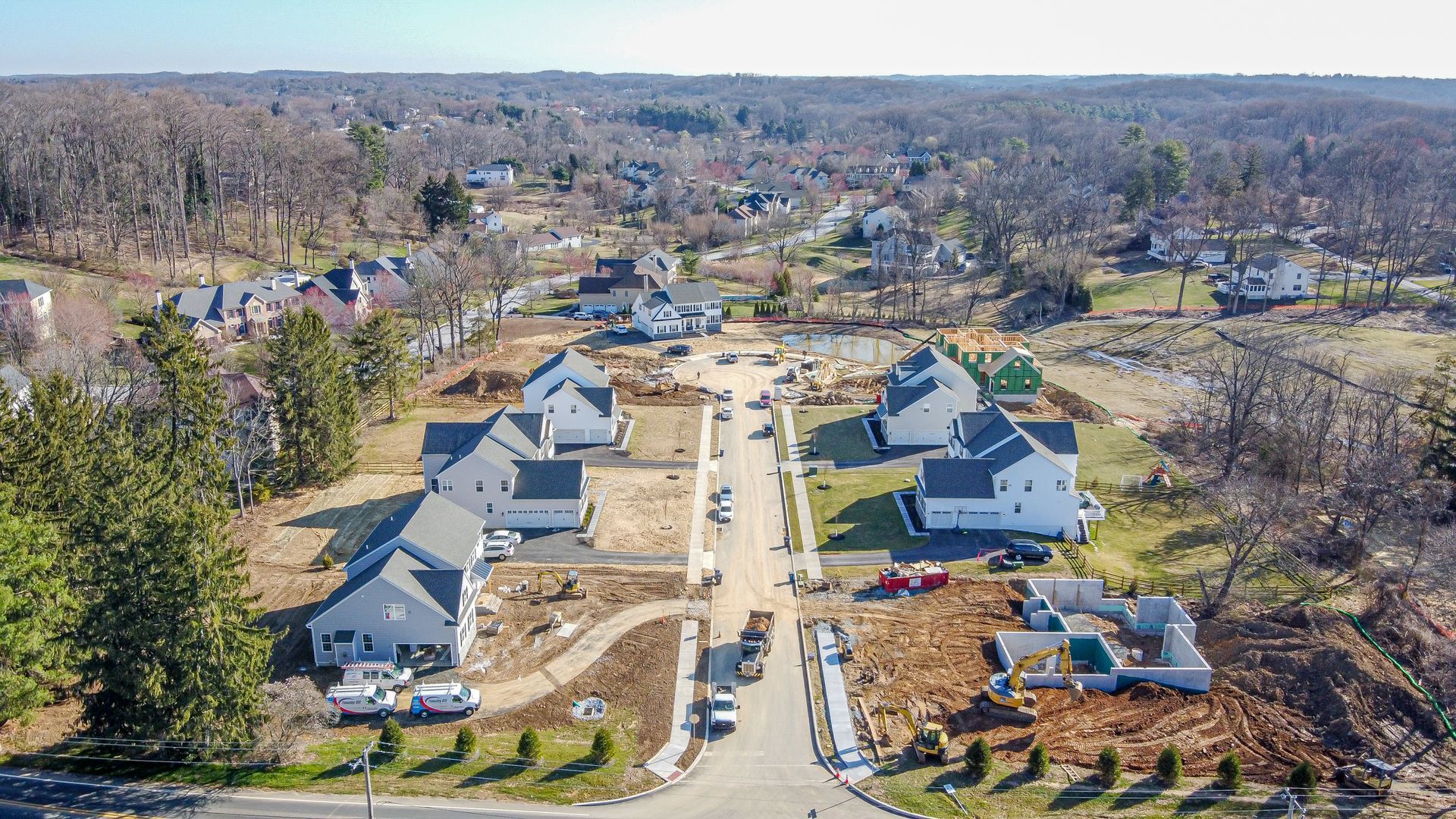 An aerial view of a residential neighborhood with lots of houses and trees.