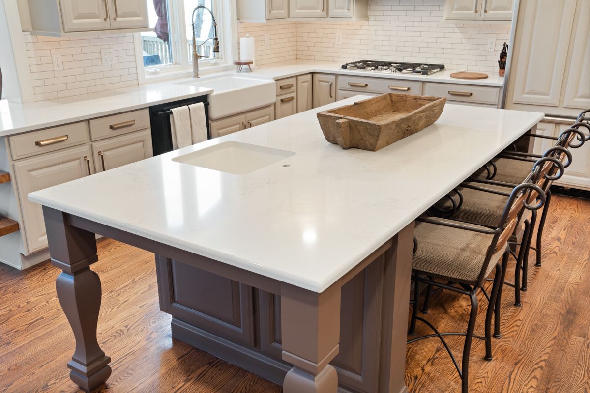 There is a large island in the middle of the kitchen.
