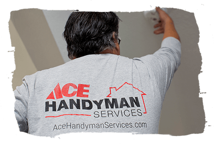 Three people smiling, wearing gray polo shirts. They are standing in front of a vehicle.