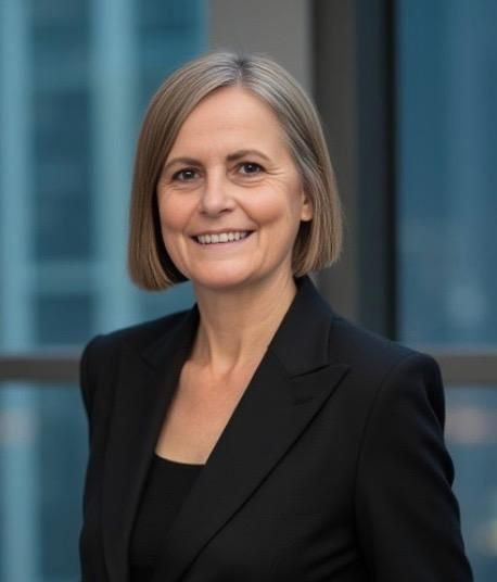 a woman in a red jacket is smiling for the camera .