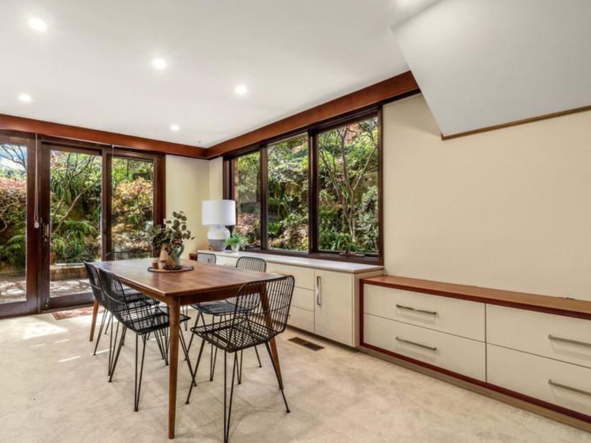 A Living Room With a Couch, Table, and Large Windows Overlooking the Ocean — A&J Painting In Belconnen, NT