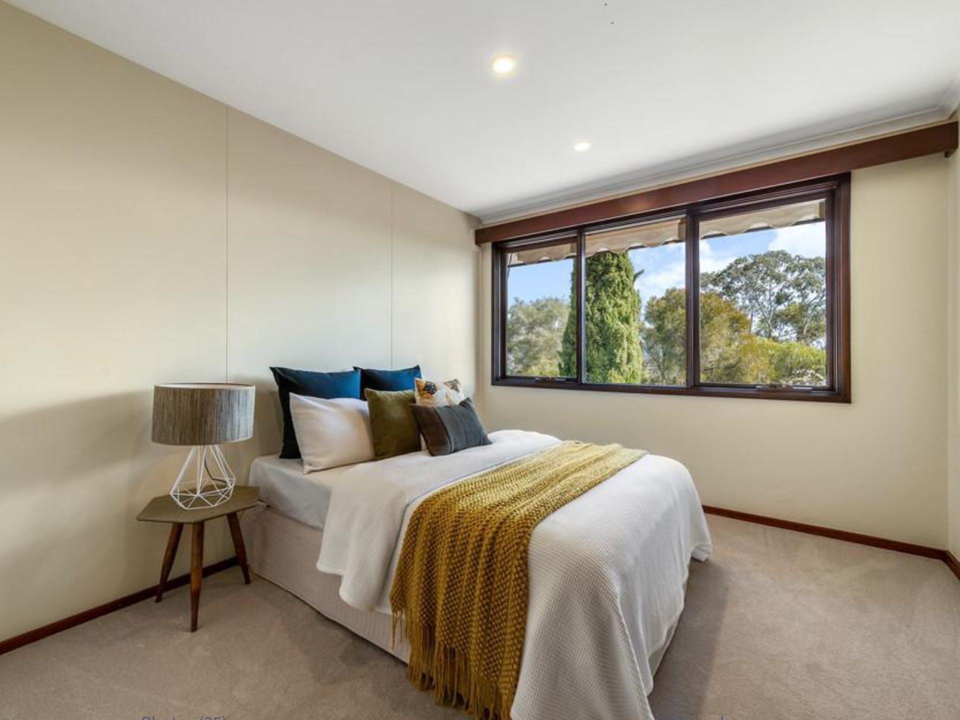 A Bedroom With Beige Walls, Large Windows and a Bed — A&J Painting In Gungahlin, NT