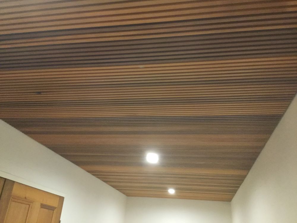 A Room With a Wooden Ceiling and a Door — A&J Painting In Gungahlin, NT