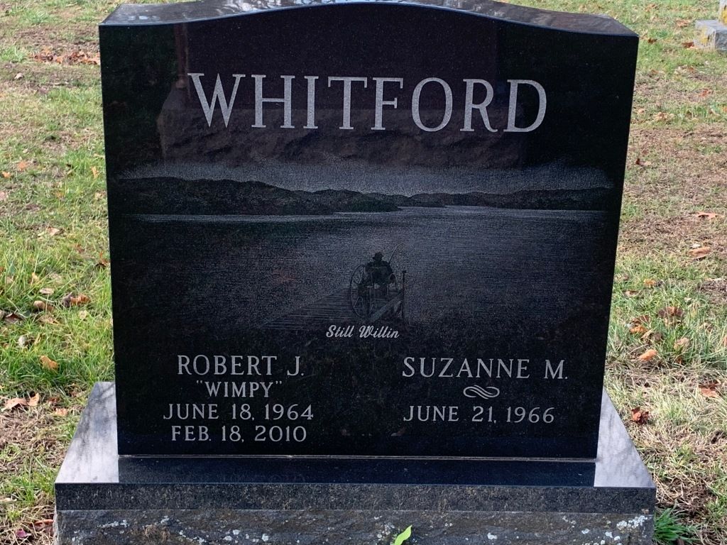 A black gravestone with the name whitford on it