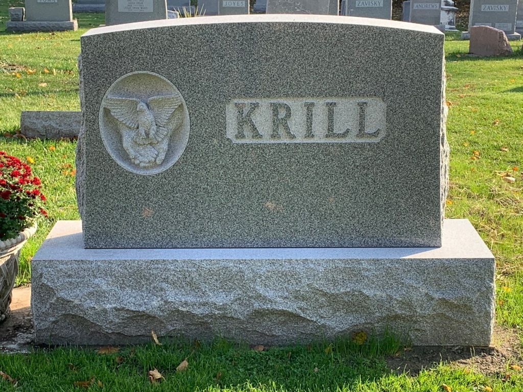 A gravestone in a cemetery with the name krill written on it