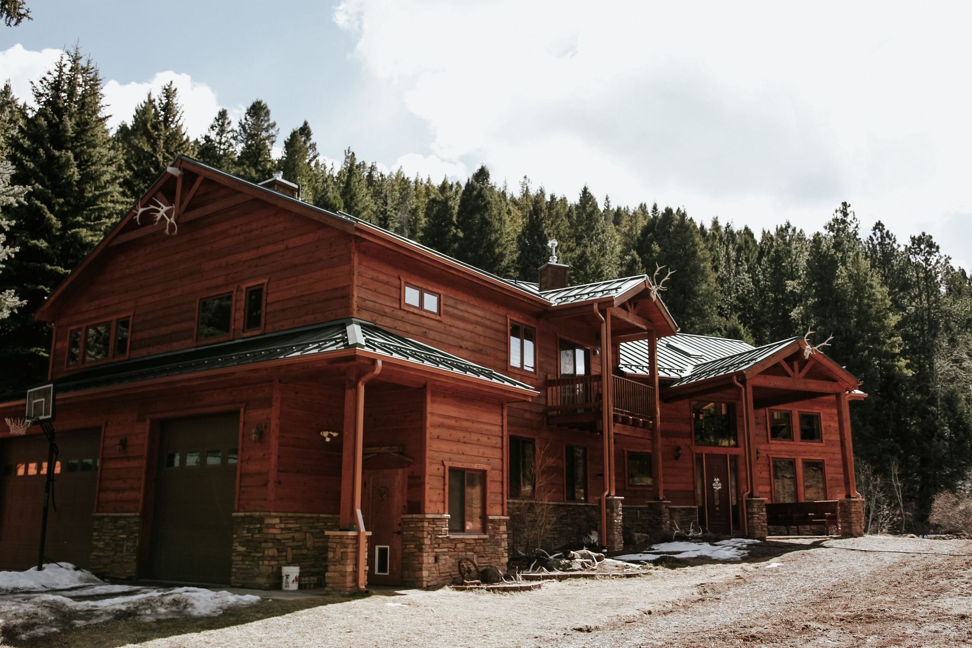 A large wooden house in the middle of a forest