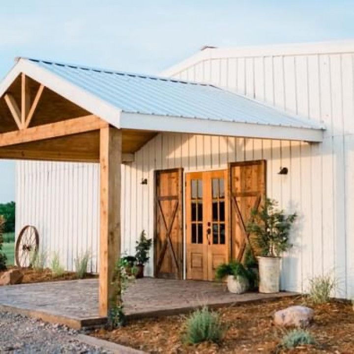 A white building with wooden doors and a white roof