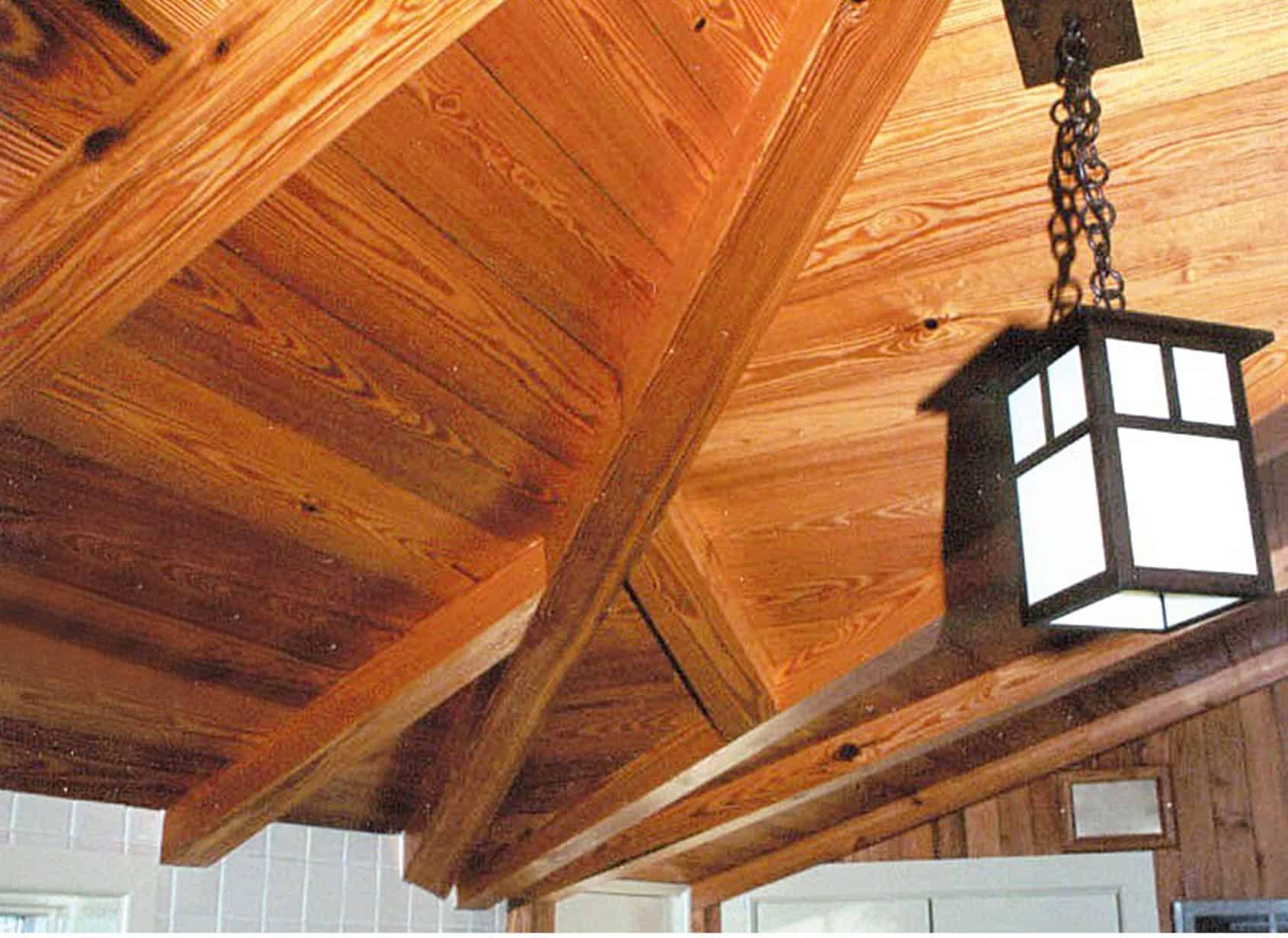 Wooden vaulted ceiling with exposed beams. A hanging lantern illuminates the space.