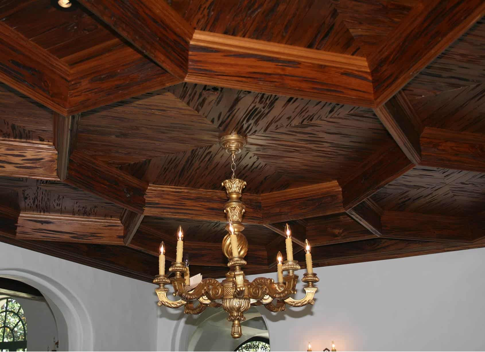 Ornate wood paneled ceiling with gold chandelier.