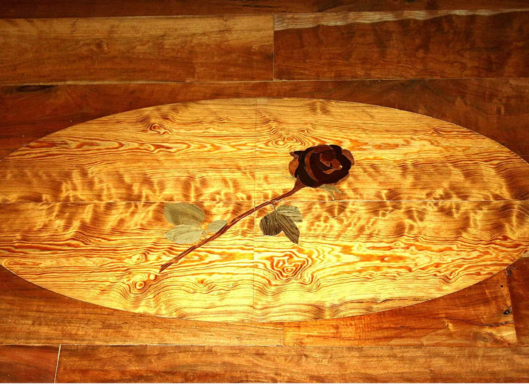 Wooden floor inlay with a rose design.