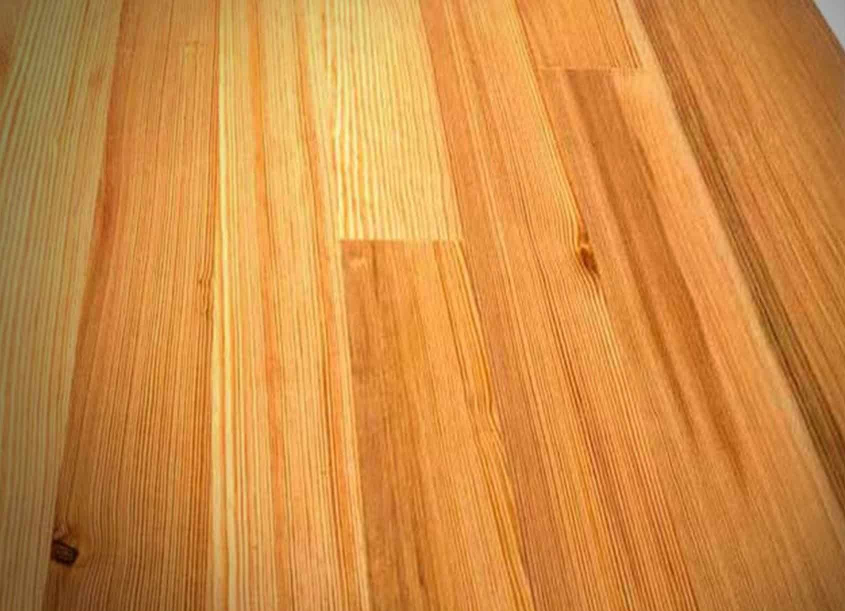 Close-up view of light-colored hardwood flooring with wood grain patterns.