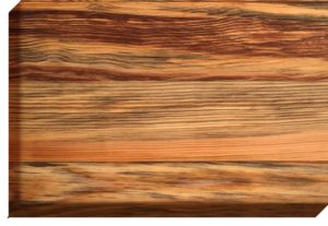 Close-up of a wooden surface with a striped pattern, featuring shades of brown, black, and orange.