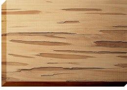 Close-up of a light-brown wooden plank with elongated, darker streaks and visible grain.