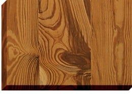 Close-up of wooden planks with swirling grain patterns in shades of brown and tan.