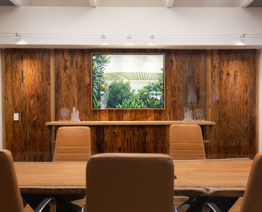 Conference room with wood paneling, artwork, and leather chairs.