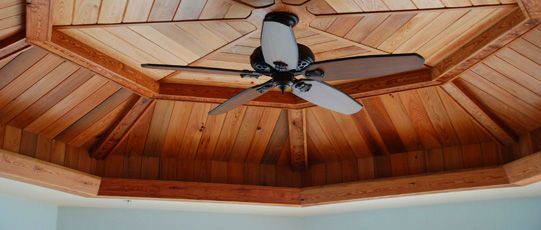 Wooden octagonal ceiling with ceiling fan.