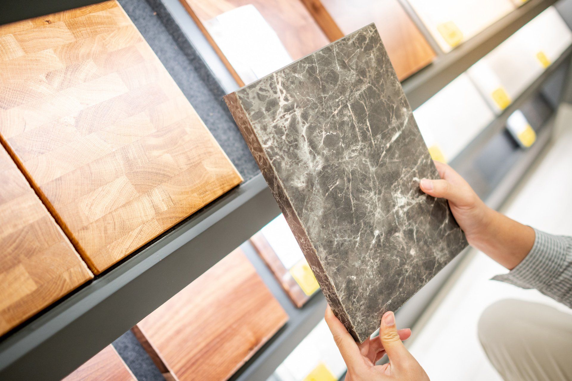 Person looking at tile sample | Home Design Center | Homebuyer Resources | Trinity Homes | Columbus, Ohio 43231