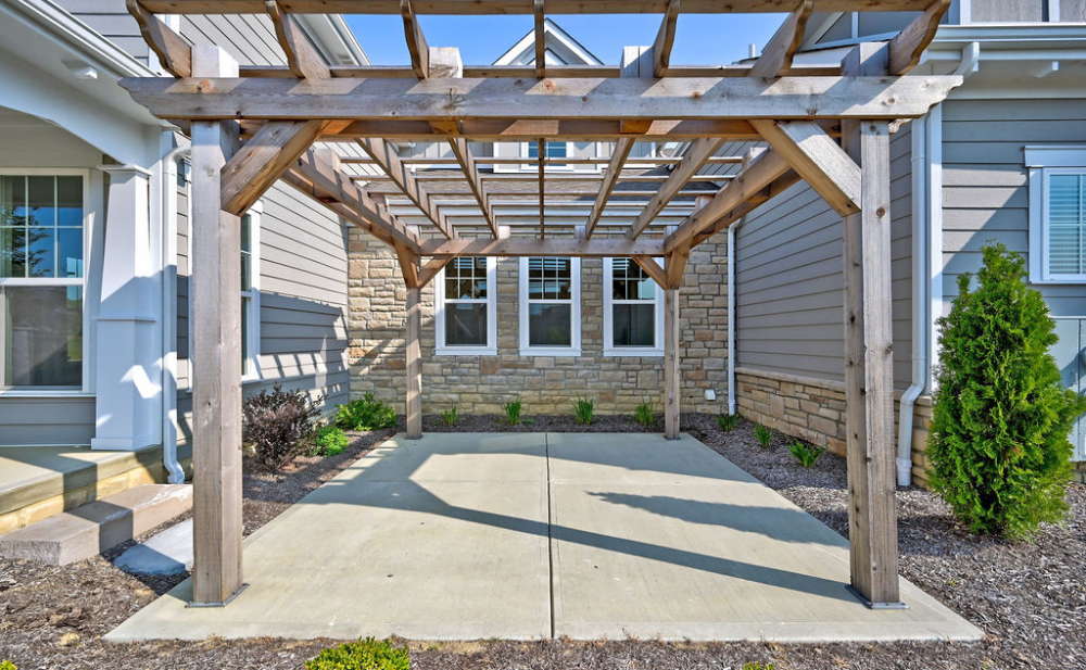 An outdoor patio with pergola at a custom home built by Trinity Homes. 