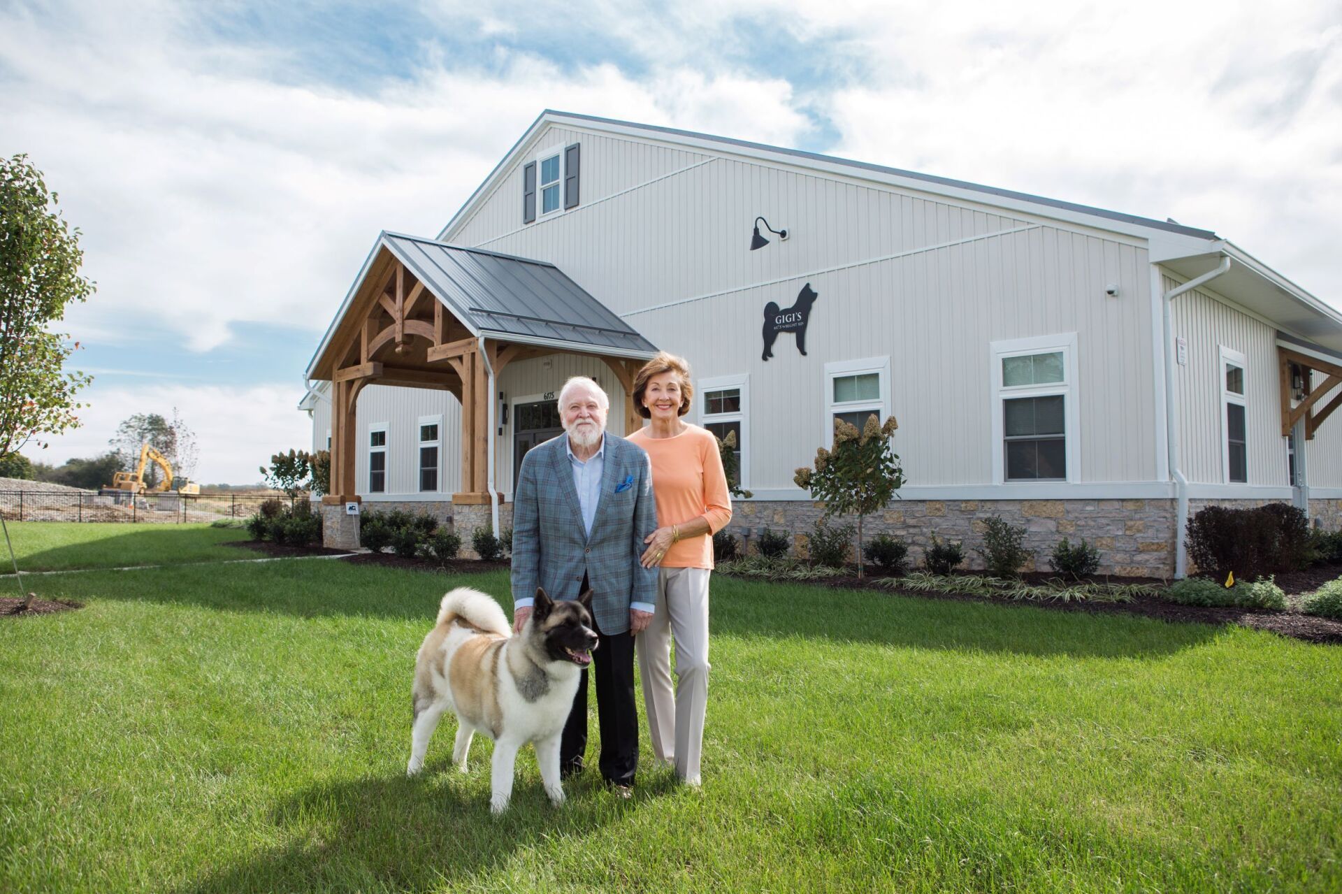Elderly couple standing with dog in front of building | Gigi's Shelter for Dogs | Giving Back | Why Trinity | Trinity Homes | Columbus, Ohio 43231