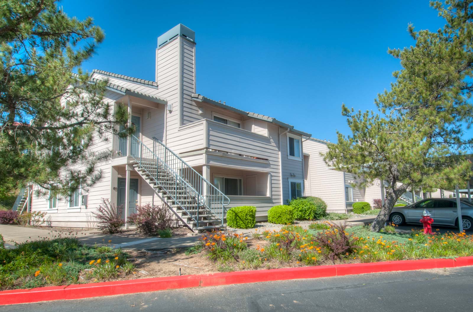 An exterior view of the apartment complex including the parking area