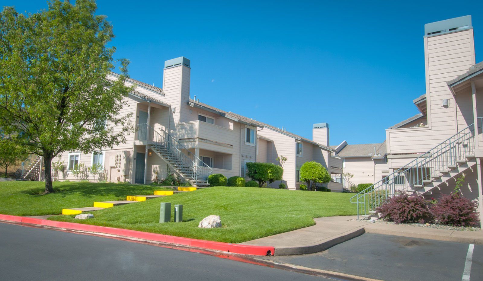 Another exterior view of the apartment complex including the parking area
