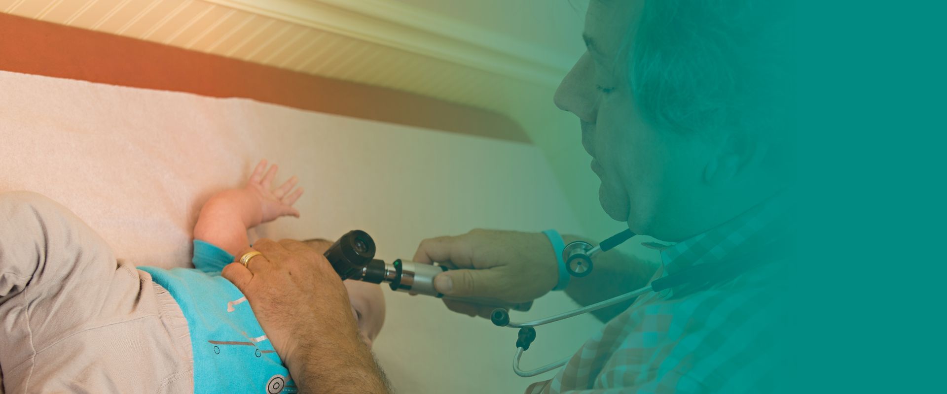 A doctor is examining a baby 's ear with a medical instrument.