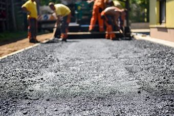 construction workers laying asphalt