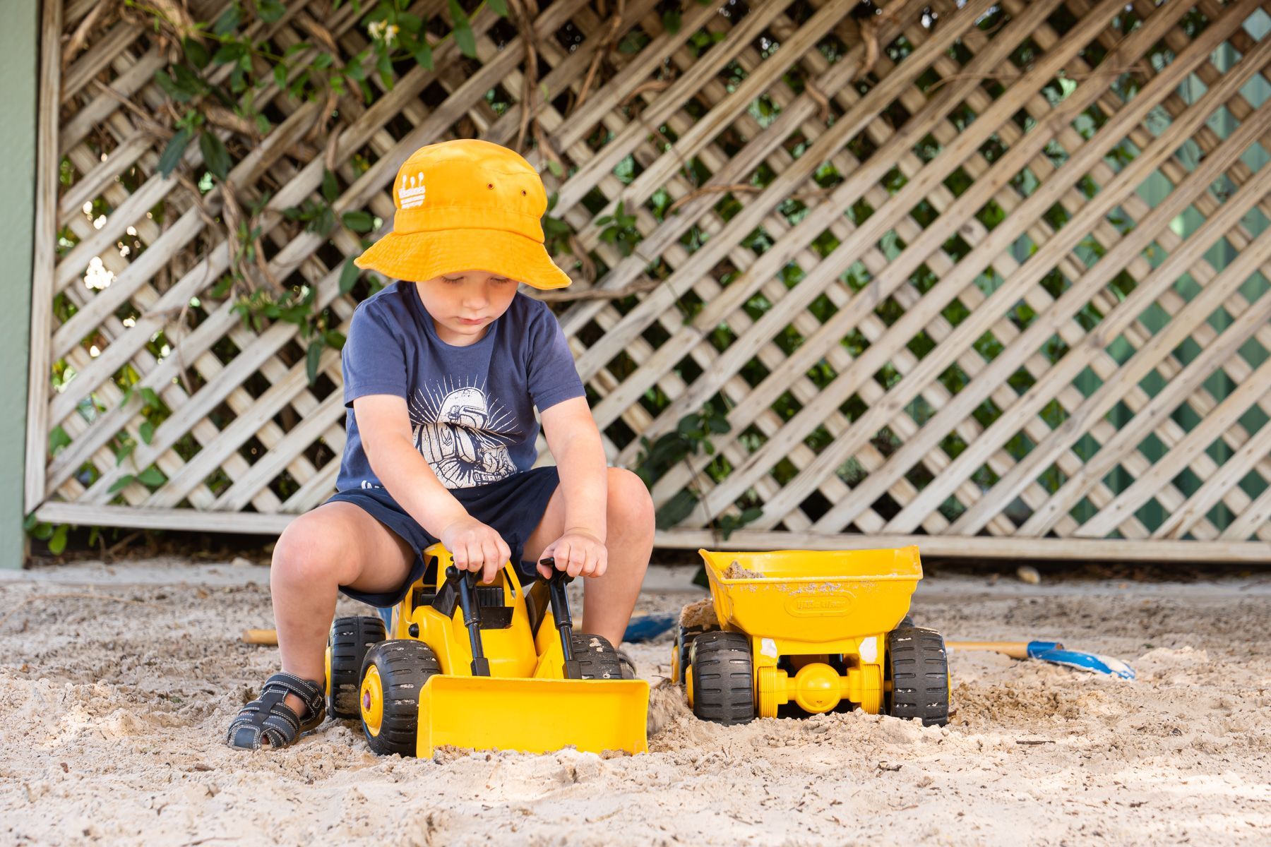 Little boy playing with toy trucks