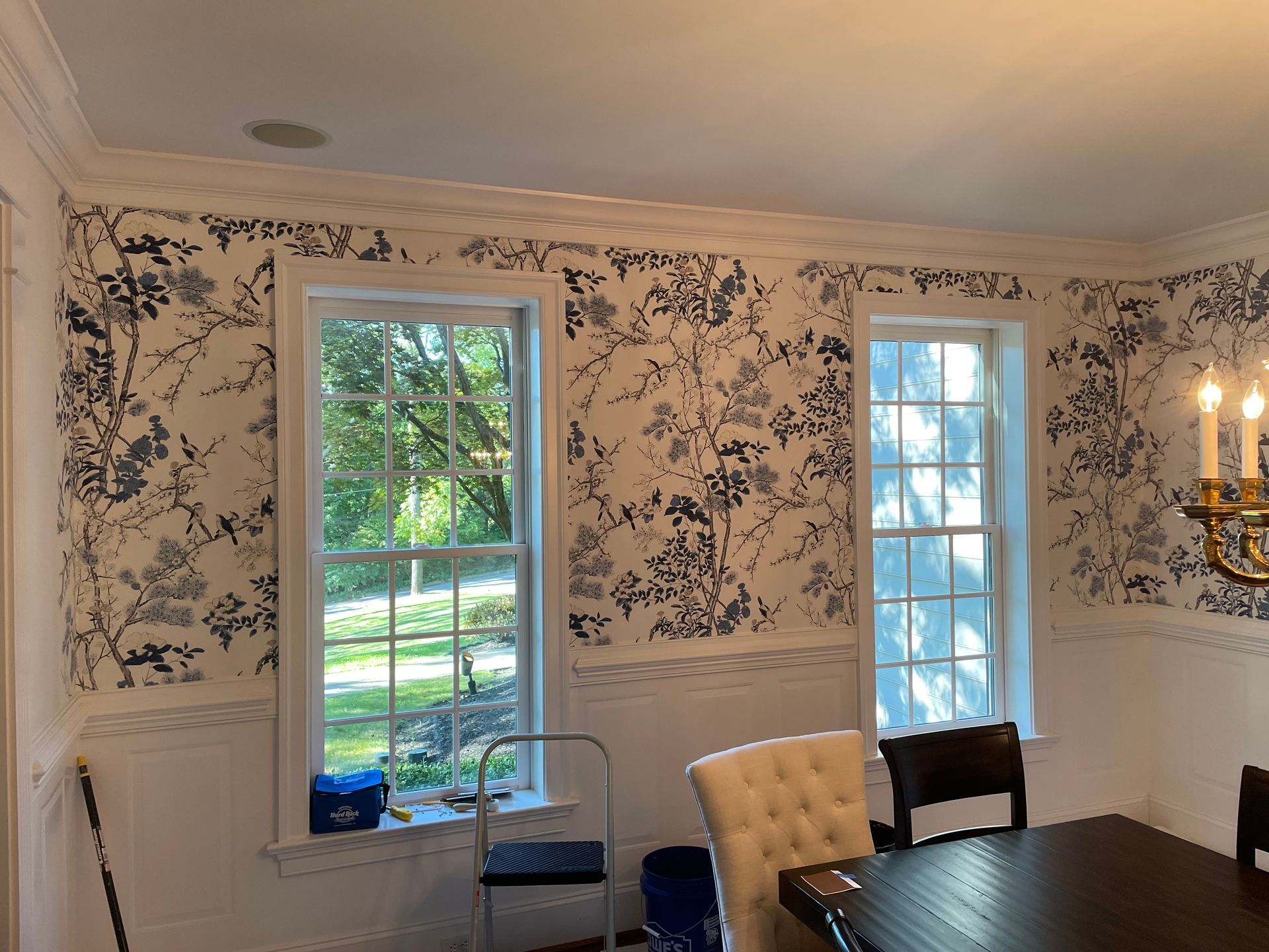 A dining room with a table and chairs and a chandelier.