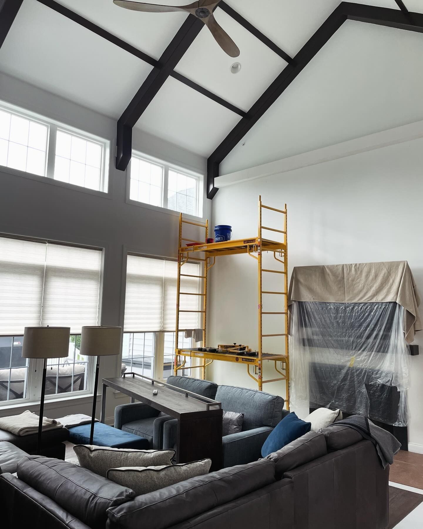 A living room with a couch and a ceiling fan