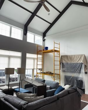 A living room with a couch and a ceiling fan