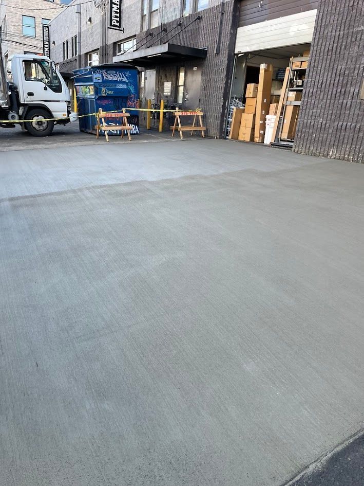 A truck is parked in a parking lot in front of a building.