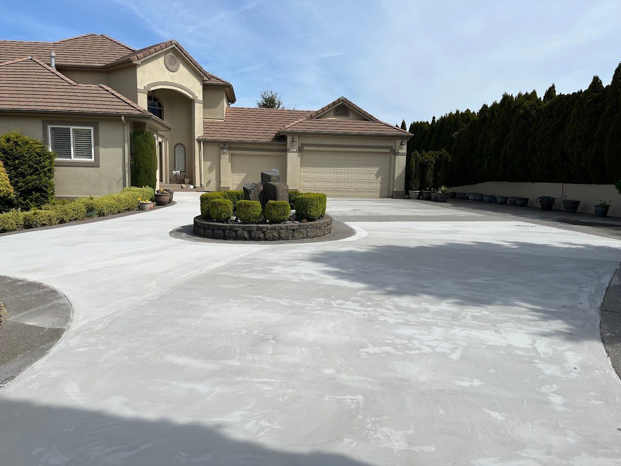 A large house with a concrete driveway in front of it