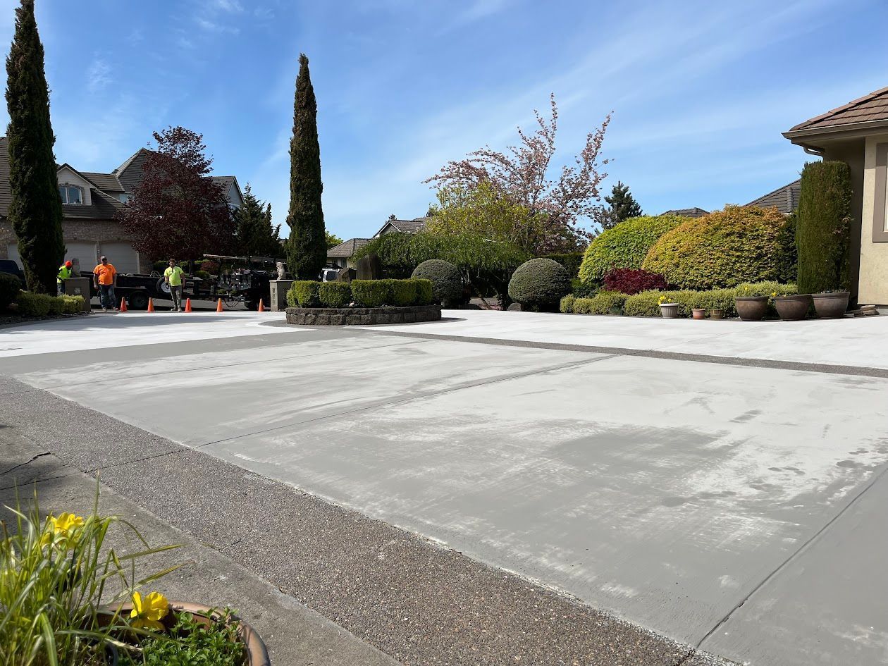 A concrete driveway is being built in front of a house.