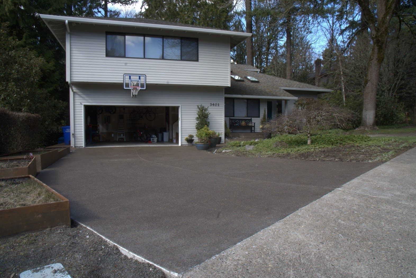 A house with a basketball hoop in the driveway.