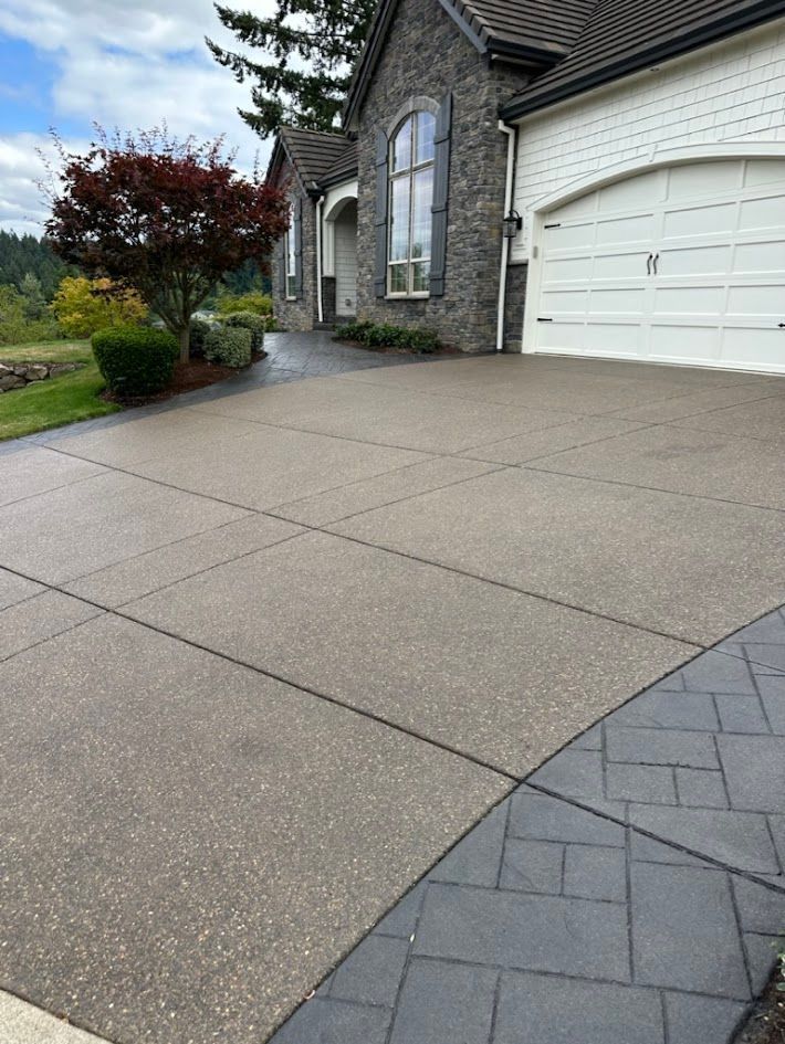 A driveway leading to a house with a white garage door.