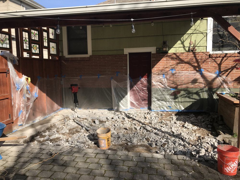 A brick house with a covered patio in front of it.