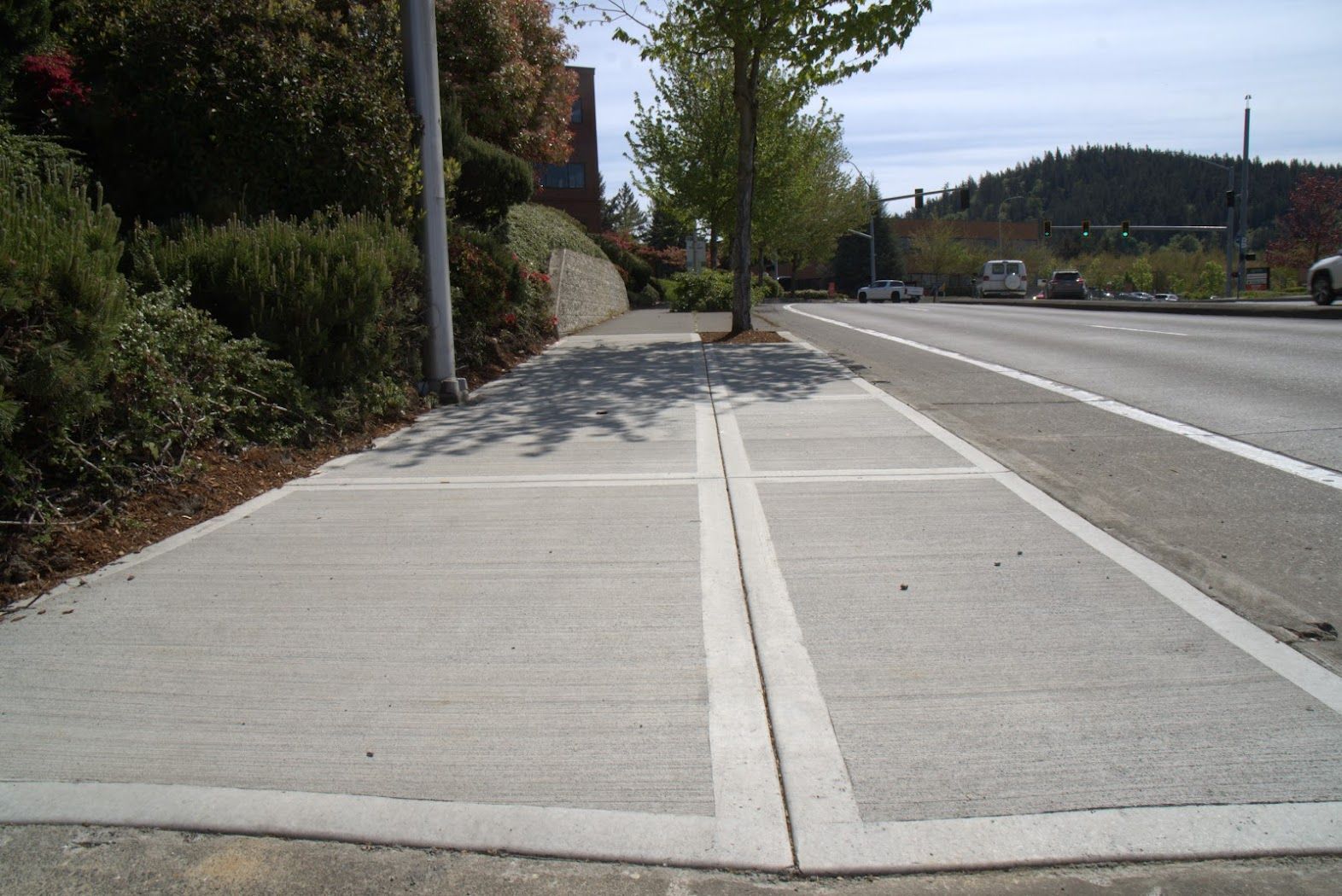 A concrete sidewalk along the side of a road