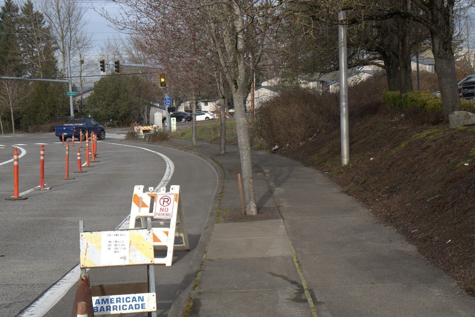 A street with a no parking sign on the sidewalk