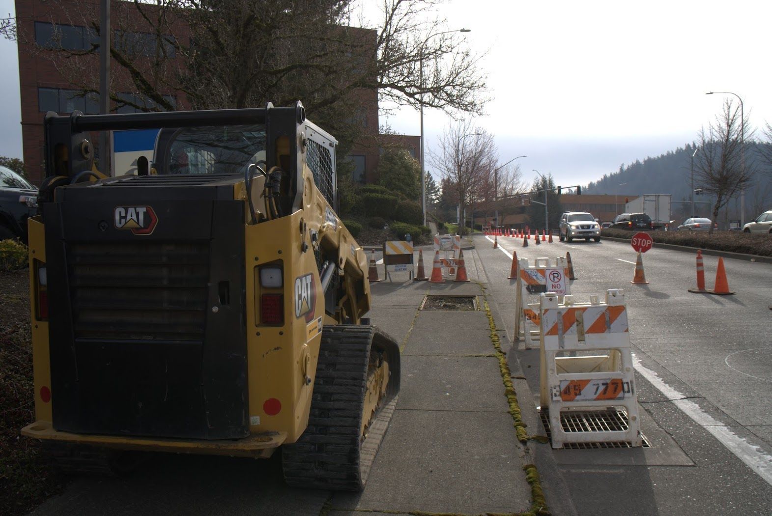A cat bulldozer is parked on the side of the road