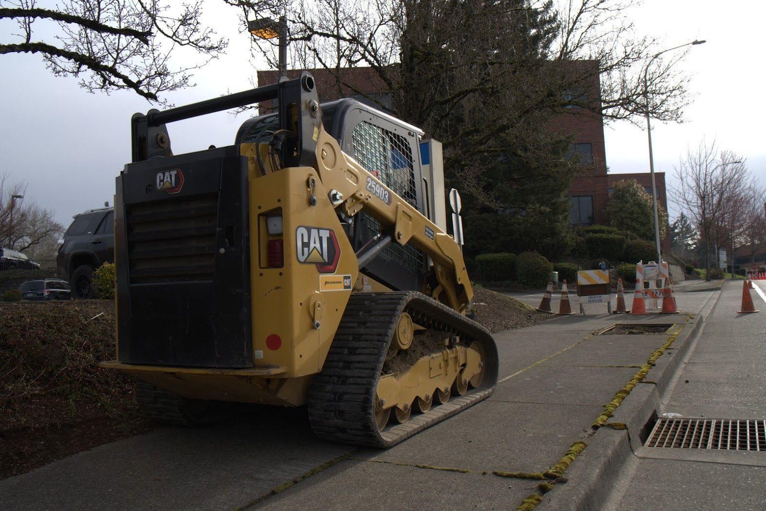 A cat bulldozer is parked on the side of the road