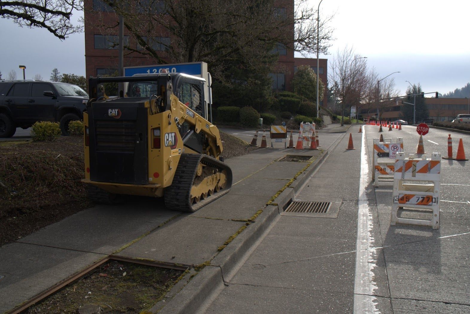 A cat bulldozer is parked on the side of the road