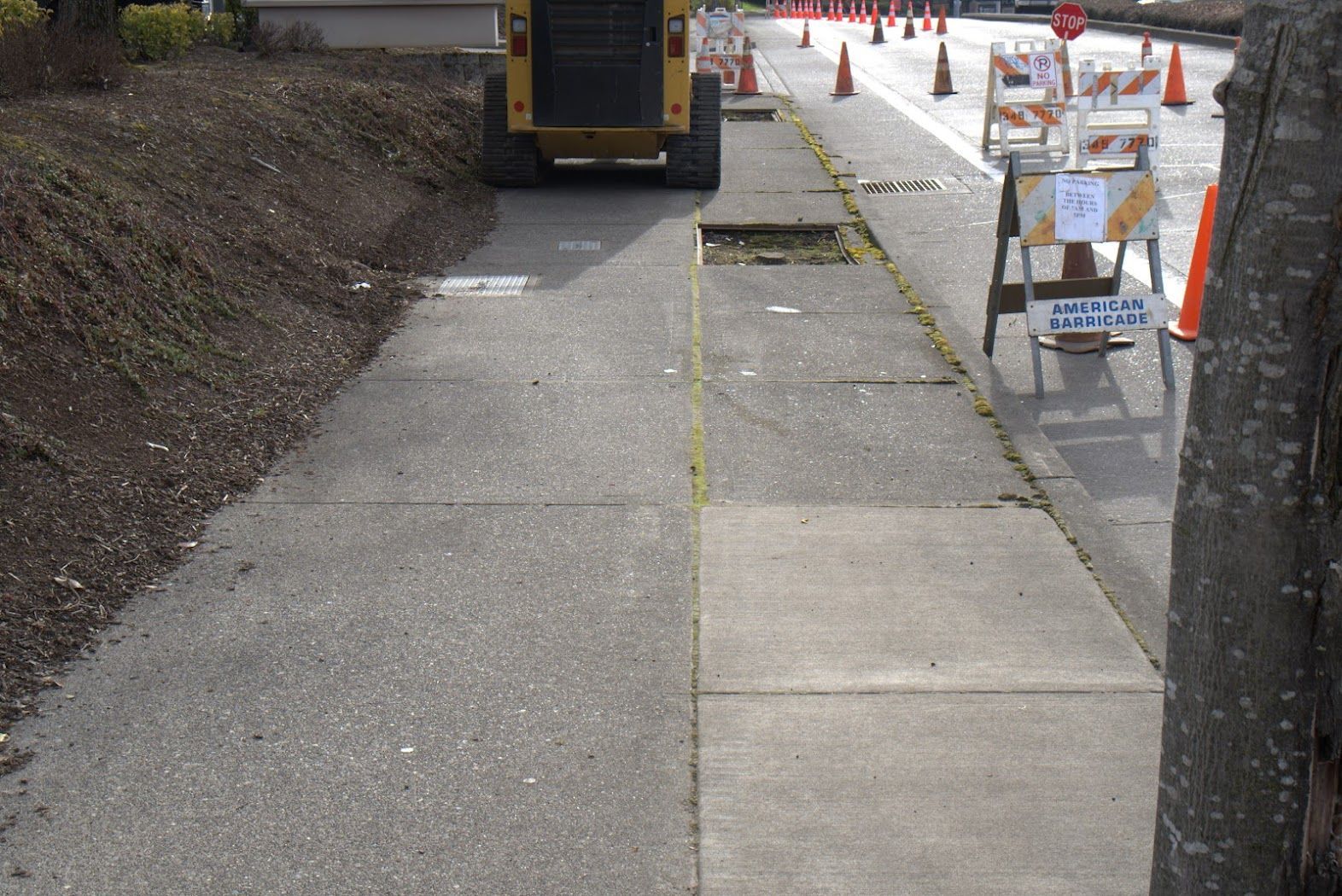 A concrete sidewalk with a yellow line on it
