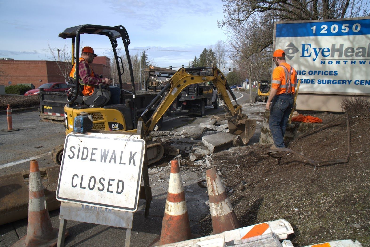 A construction site with a sign that says sidewalk closed