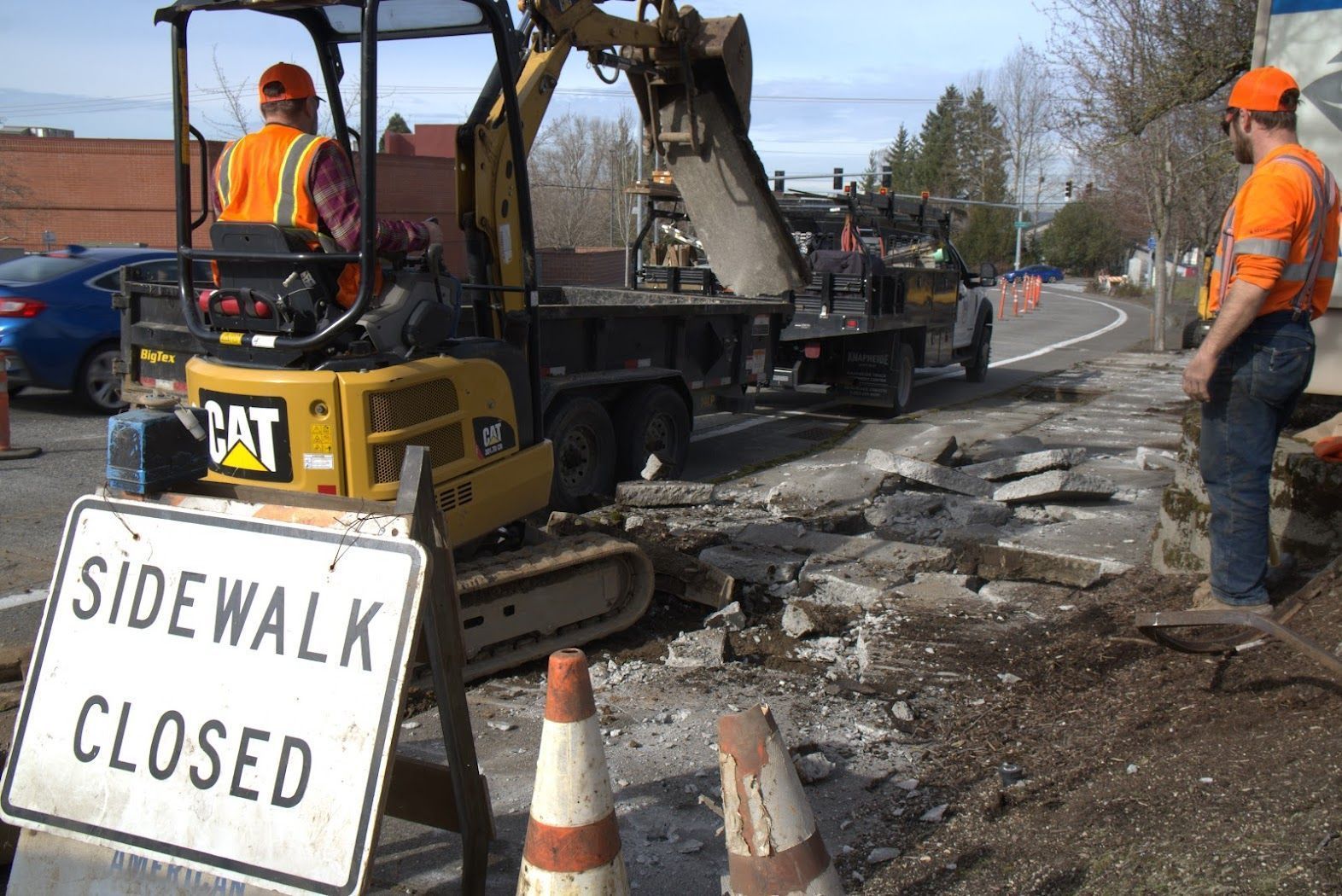 A construction site with a sign that says sidewalk closed