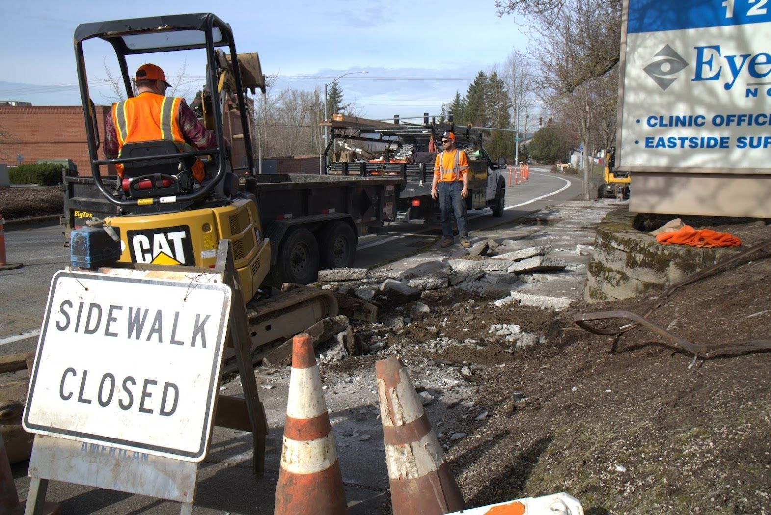 A construction site with a sidewalk closed sign