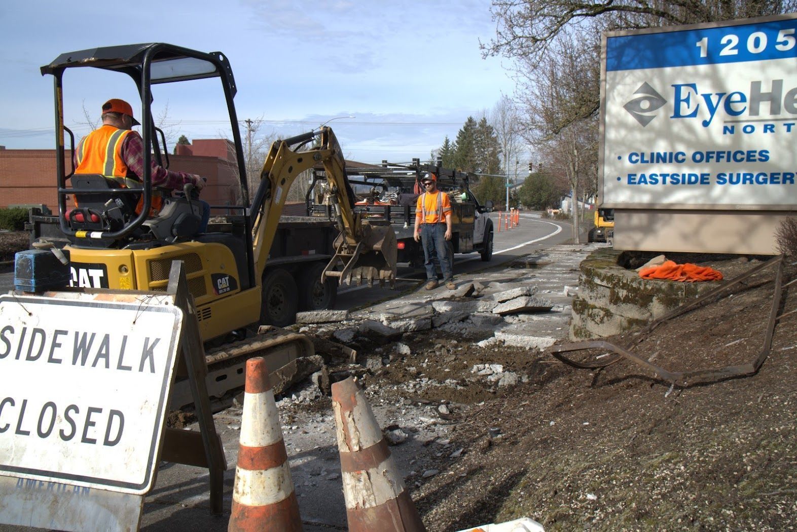 A construction site with a sign that says sidewalk closed