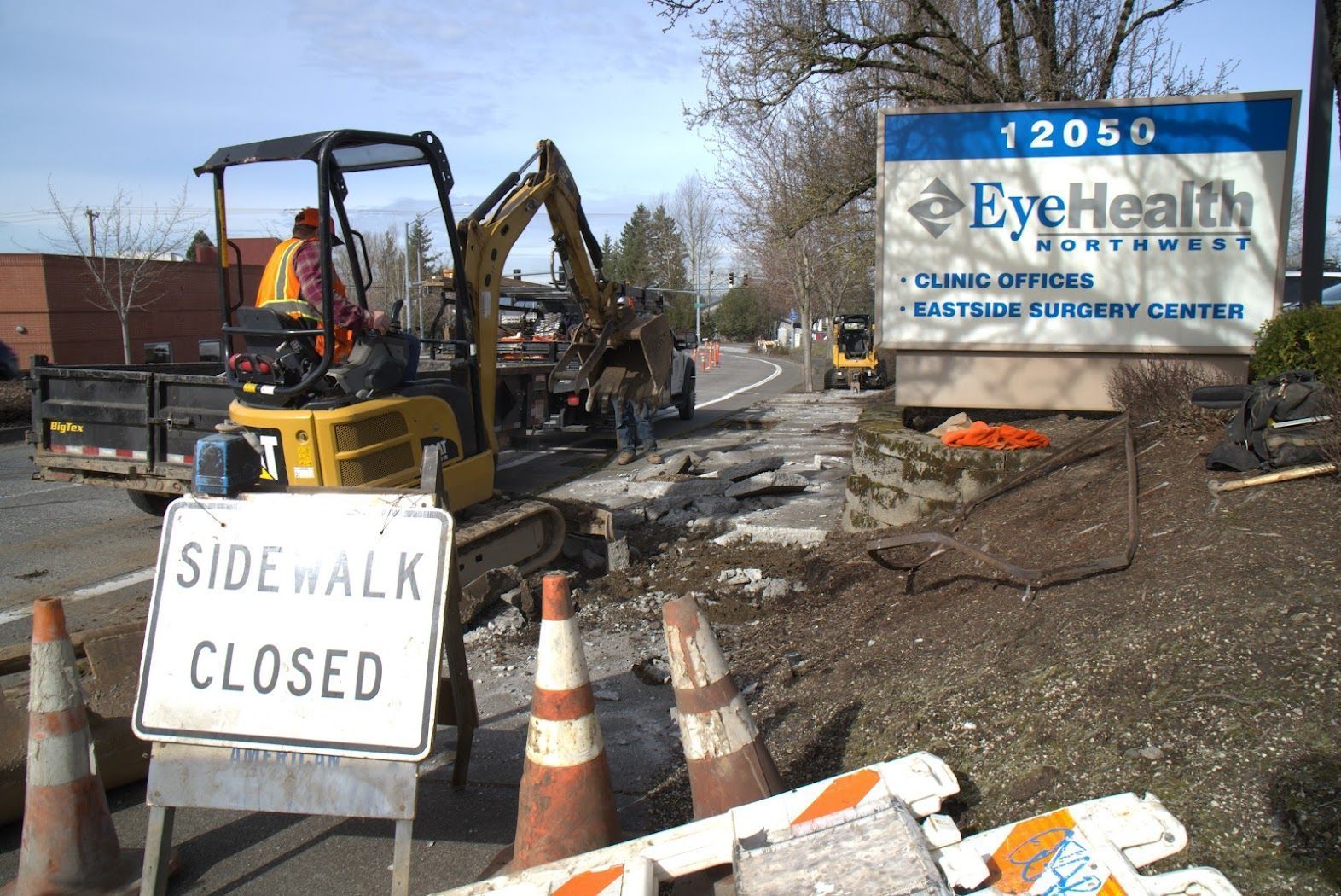 A sidewalk is closed in front of a sign for eye health