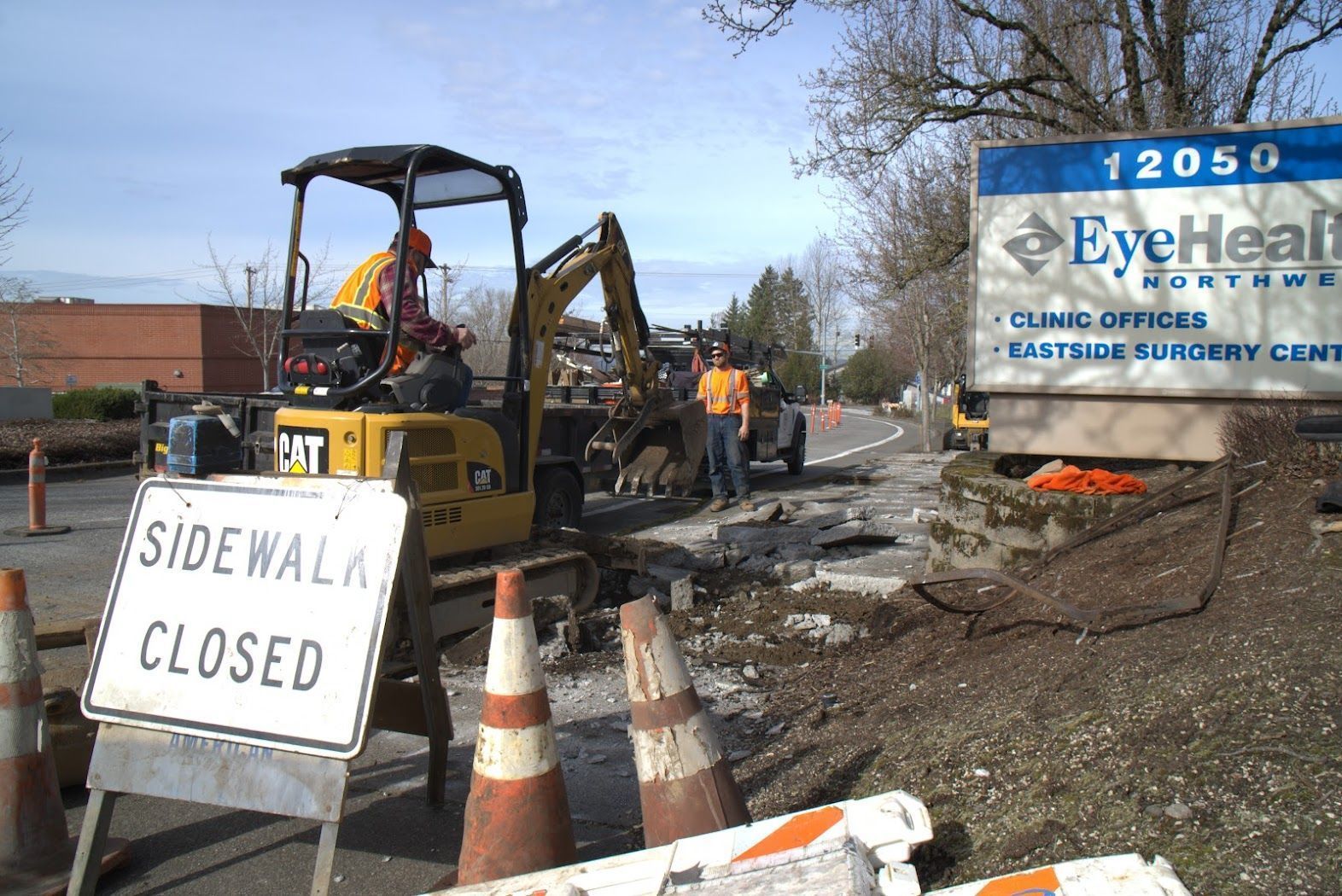 A construction site with a sign that says sidewalk closed
